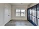 Bright bedroom features large window, gray wood floors, and a striking set of black closet doors at 3540 Paddocks Pkwy, Suwanee, GA 30024