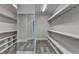 Walk in closet with wire shelving, ample storage space and mirror at 3540 Paddocks Pkwy, Suwanee, GA 30024