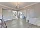 Dining room with hardwood floors, chandelier, and view to the foyer and stairs at 3540 Paddocks Pkwy, Suwanee, GA 30024