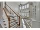 Grand entryway with a soaring ceiling, staircase, and many windows providing natural light at 3540 Paddocks Pkwy, Suwanee, GA 30024