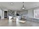 Bright, open kitchen features gray cabinets, stainless appliances, and a large island with seating at 3540 Paddocks Pkwy, Suwanee, GA 30024