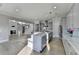 Open-concept kitchen and living area with gray cabinets, stainless steel appliances, and hardwood floors at 3540 Paddocks Pkwy, Suwanee, GA 30024