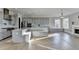 Modern kitchen with gray cabinets, stainless steel appliances, island, and light wood floors at 3540 Paddocks Pkwy, Suwanee, GA 30024