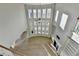 Bright living room with soaring ceilings, fireplace, and a wall of windows offering plenty of natural light at 3540 Paddocks Pkwy, Suwanee, GA 30024