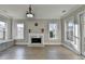 Sunlit living room featuring a fireplace, built-in seating, and windows at 3540 Paddocks Pkwy, Suwanee, GA 30024