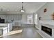 Living room with a fireplace, built-in bench seating, and gray kitchen in view at 3540 Paddocks Pkwy, Suwanee, GA 30024
