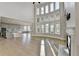 Bright living room with a wall of windows, fireplace, and light wood floors at 3540 Paddocks Pkwy, Suwanee, GA 30024