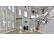 Bright open living area with a fireplace, built-in bookshelves, and lots of natural light at 3540 Paddocks Pkwy, Suwanee, GA 30024