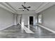 Spacious main bedroom featuring tray ceilings, ceiling fan and hardwood floors with access to the Main Bathroom at 3540 Paddocks Pkwy, Suwanee, GA 30024