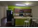 A colorful kitchen with an island, dark wood cabinets, and modern appliances at 2087 Belmont Cir, Conyers, GA 30012