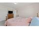 Bedroom featuring neutral walls, carpet, and a wooden dresser, offering space for relaxation and personal touches at 403 Sonja Ln, Loganville, GA 30052