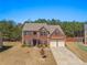 Charming brick two-story home featuring an attached two-car garage and a well-manicured lawn at 403 Sonja Ln, Loganville, GA 30052