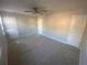 Spacious bedroom featuring three doors, neutral walls, carpeted floor, and a ceiling fan at 6104 Cobblestone Ct, Douglasville, GA 30134