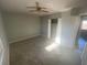 Bedroom featuring an open closet and a window allowing natural light to illuminate the carpeted floor at 6104 Cobblestone Ct, Douglasville, GA 30134
