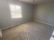 Bedroom with a window allowing natural light to illuminate the carpeted floor at 6104 Cobblestone Ct, Douglasville, GA 30134