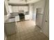 Well-lit kitchen featuring white cabinets, stainless steel appliances, and tile floors at 6104 Cobblestone Ct, Douglasville, GA 30134