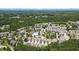 Aerial view of the neighborhood showcases the homes, lush landscaping, and surrounding wooded areas and community pool at 921 Ambient Sw Way, Atlanta, GA 30331