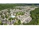 Aerial view of the neighborhood showcases the community, lush landscaping, and surrounding wooded areas and community pool at 921 Ambient Sw Way, Atlanta, GA 30331