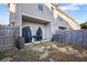 Back patio with fenced yard with potential for outdoor living and entertaining with mature trees at 921 Ambient Sw Way, Atlanta, GA 30331