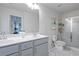 Bright bathroom with double vanity, white marble floors, and glass-enclosed shower at 921 Ambient Sw Way, Atlanta, GA 30331