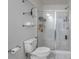 The clean, bright bathroom features a toilet, glass shelves, and a glass-enclosed shower at 921 Ambient Sw Way, Atlanta, GA 30331