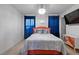 Cozy bedroom with vibrant orange bedframe, plush carpet, and modern light fixture at 921 Ambient Sw Way, Atlanta, GA 30331