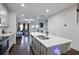 Kitchen island with stainless steel sink, light gray cabinets, and dark wood floors at 921 Ambient Sw Way, Atlanta, GA 30331