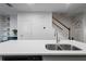 Kitchen island with a stainless steel sink, quartz countertop, and stainless steel dishwasher at 921 Ambient Sw Way, Atlanta, GA 30331