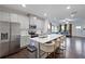 Spacious kitchen with a center island and stainless steel appliances overlooking the living area at 921 Ambient Sw Way, Atlanta, GA 30331