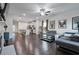 Open-concept living room featuring a modern kitchen, a comfortable sofa, and hardwood floors at 921 Ambient Sw Way, Atlanta, GA 30331
