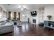 Bright living room featuring hardwood floors, a fireplace, and a comfortable seating area at 921 Ambient Sw Way, Atlanta, GA 30331