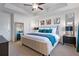 Primary bedroom featuring a padded headboard, tray ceiling, and neutral carpet at 921 Ambient Sw Way, Atlanta, GA 30331