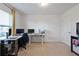 Bright home office with multiple monitors, white desk, and large window allowing plenty of natural light at 921 Ambient Sw Way, Atlanta, GA 30331
