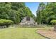 Stone monument sign with water feature and landscaping provides an elegant entry to the community and inviting curb appeal at 921 Ambient Sw Way, Atlanta, GA 30331