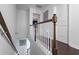 Staircase with wooden railing and white balusters, showing the upstairs hallway at 921 Ambient Sw Way, Atlanta, GA 30331