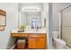 Well-lit bathroom featuring vanity with storage space, decorative wallpaper, and shower with glass door at 135 Wilbanks Dr, Fayetteville, GA 30215