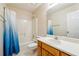 Bathroom featuring a shower-tub combo with a blue shower curtain and single sink vanity at 135 Wilbanks Dr, Fayetteville, GA 30215