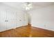 Bedroom includes hardwood floors and a large closet with plenty of storage at 135 Wilbanks Dr, Fayetteville, GA 30215