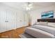 Cozy bedroom featuring hardwood floors, three closets, and an abstract painting at 135 Wilbanks Dr, Fayetteville, GA 30215
