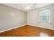 Neutral bedroom features hardwood floors, a ceiling fan, and natural light at 135 Wilbanks Dr, Fayetteville, GA 30215