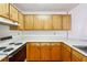 Functional kitchen features wooden cabinets and white countertops at 135 Wilbanks Dr, Fayetteville, GA 30215