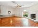 Bright living room boasts hardwood floors, fireplace, and large windows providing natural light at 135 Wilbanks Dr, Fayetteville, GA 30215