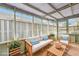 Relaxing sunroom with wicker furniture set, including a sofa and chairs with blue pillows at 135 Wilbanks Dr, Fayetteville, GA 30215