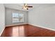 Bedroom featuring wood floors, ceiling fan, and large window at 1859 Mapmaker Dr, Dacula, GA 30019