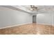 Spacious bedroom featuring tile flooring, ceiling fan, and tray ceiling at 1859 Mapmaker Dr, Dacula, GA 30019