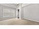 Bright bedroom featuring neutral walls, carpet, and a closet with mirrored doors at 1859 Mapmaker Dr, Dacula, GA 30019