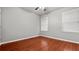 Bright bedroom with wood floors, ceiling fan, and two windows at 1859 Mapmaker Dr, Dacula, GA 30019