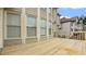 View of the back of the home from the wooden deck, showcasing the beige siding and ample windows at 1859 Mapmaker Dr, Dacula, GA 30019