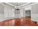 Elegant dining room with chandelier, hardwood floors, and large windows at 1859 Mapmaker Dr, Dacula, GA 30019