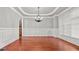 Dining room showcasing a chandelier, decorative trim, and hardwood floors at 1859 Mapmaker Dr, Dacula, GA 30019